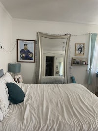 a bedroom with a bed and a mirror