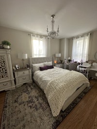 a bedroom with a bed and a dresser